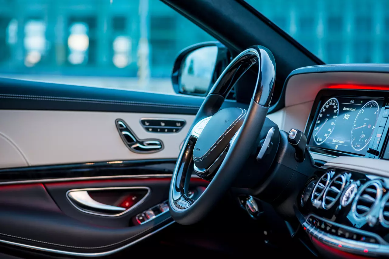 Auto. Luxury car steering wheel and dashboard with monitor