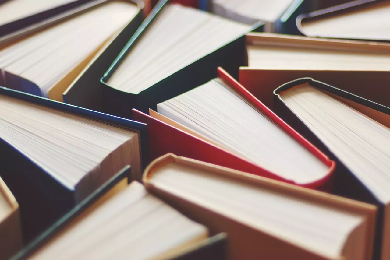 Many hardbound books background, selective focus.